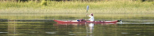 A man on a kayak in a channel